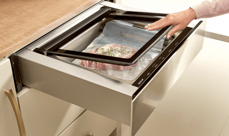 Glazed teriyaki infused rib of beef being prepped to be placed within a Wolf Vacuum Seal Drawer